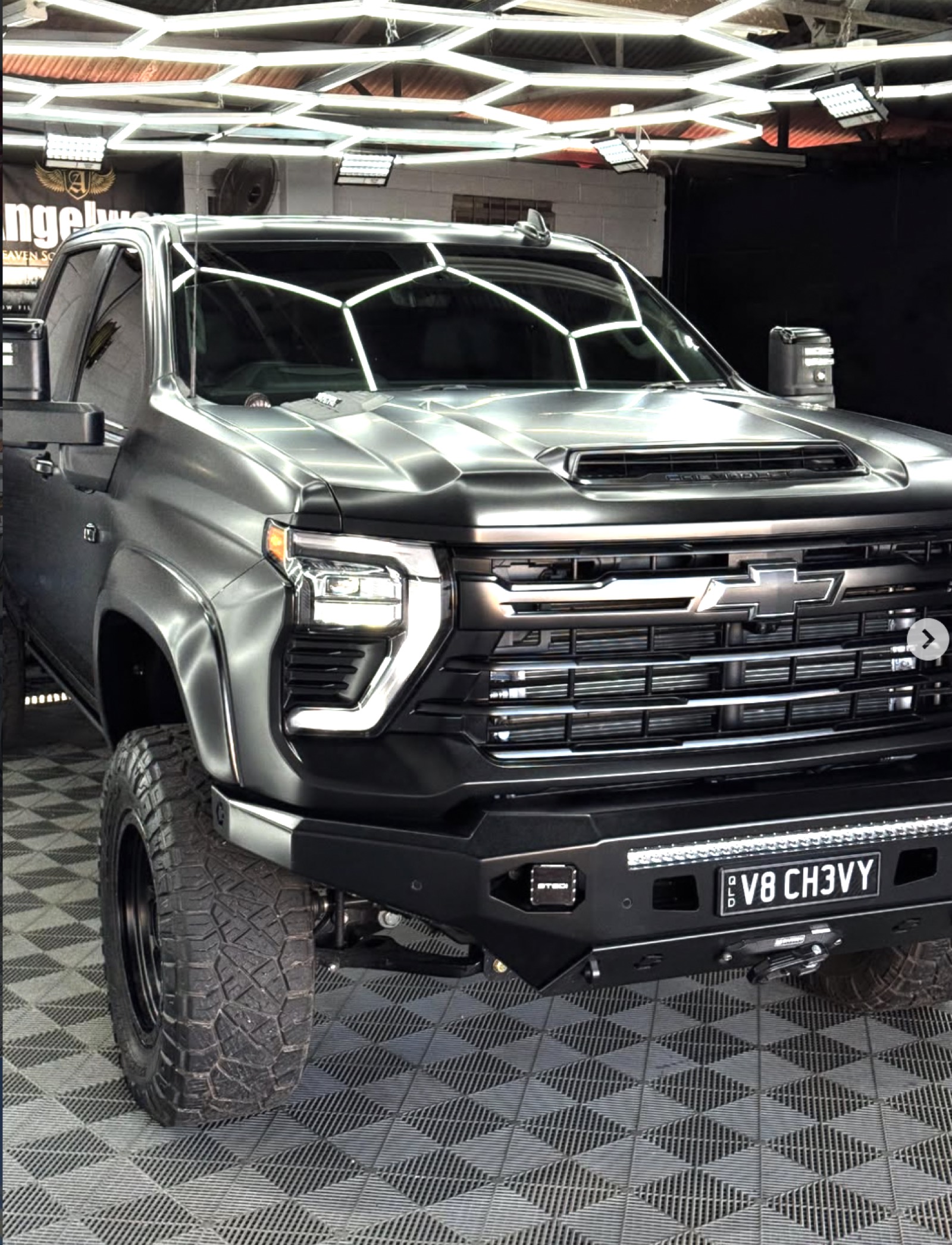 Matte black Chevrolet Silverado detailed under hex studio lighting